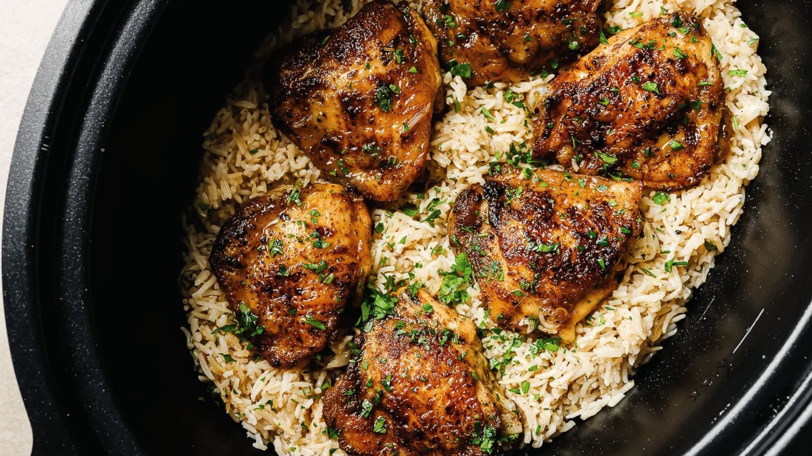 Slow cooker chicken served with rice, accompanied by cooking settings, and tips for optimal doneness.