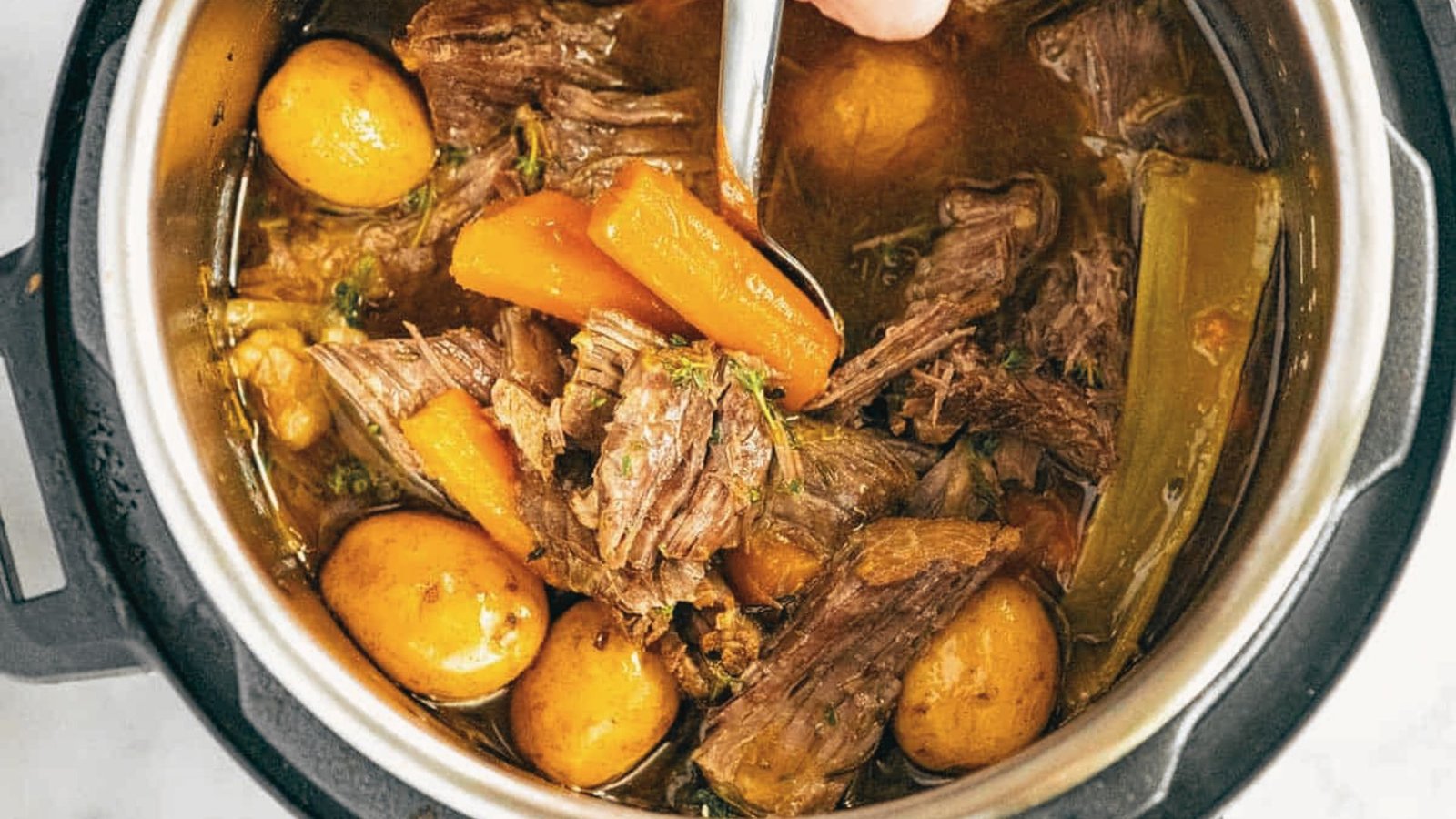 A hearty slow cooker Pikes Peak Roast prepared using the Instant Pot for a quick and flavorful meal.