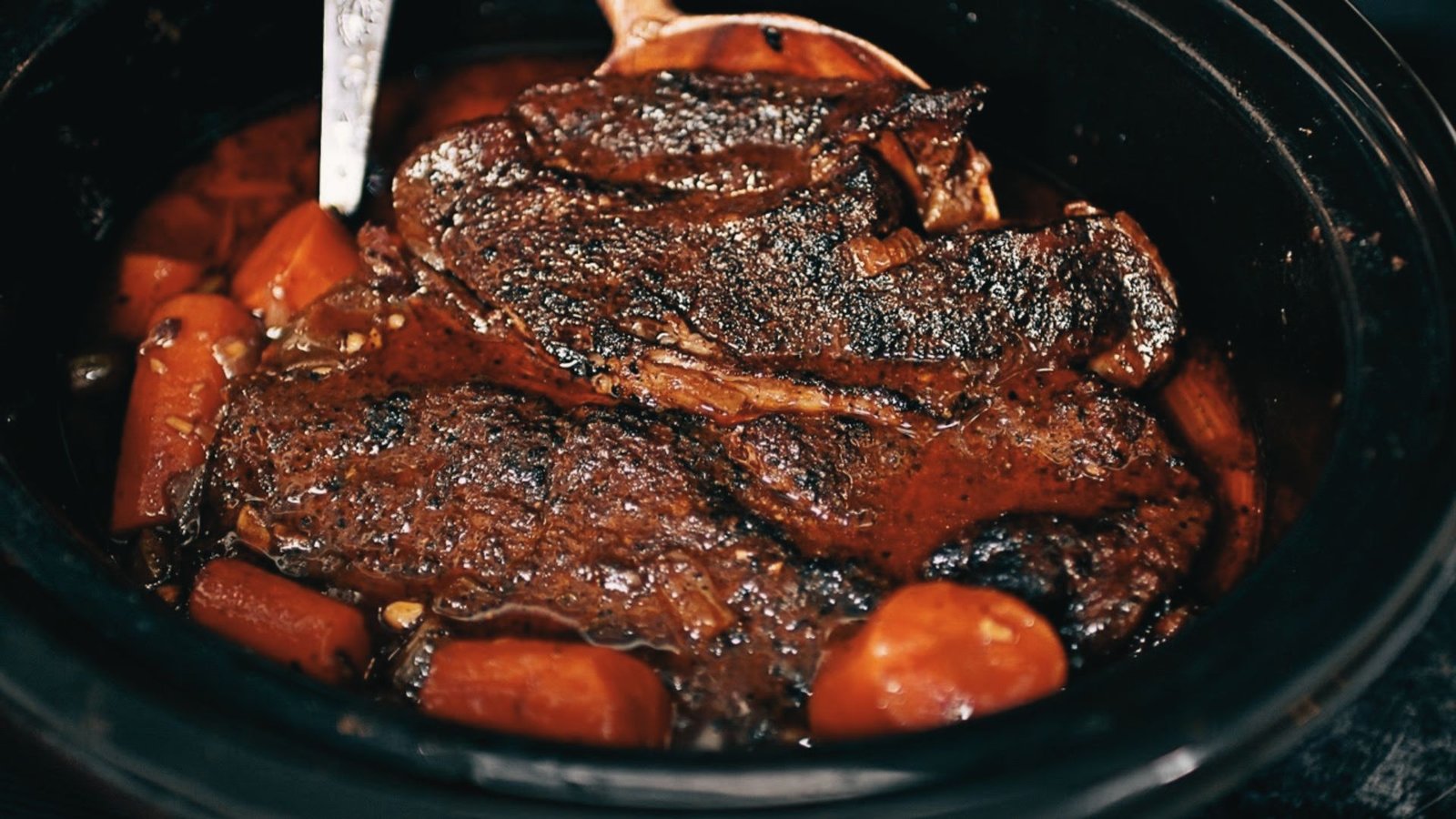 Slow cooker Pikes Peak roast on low heat in a crock pot, producing a tender, slow-cooked beef roast.