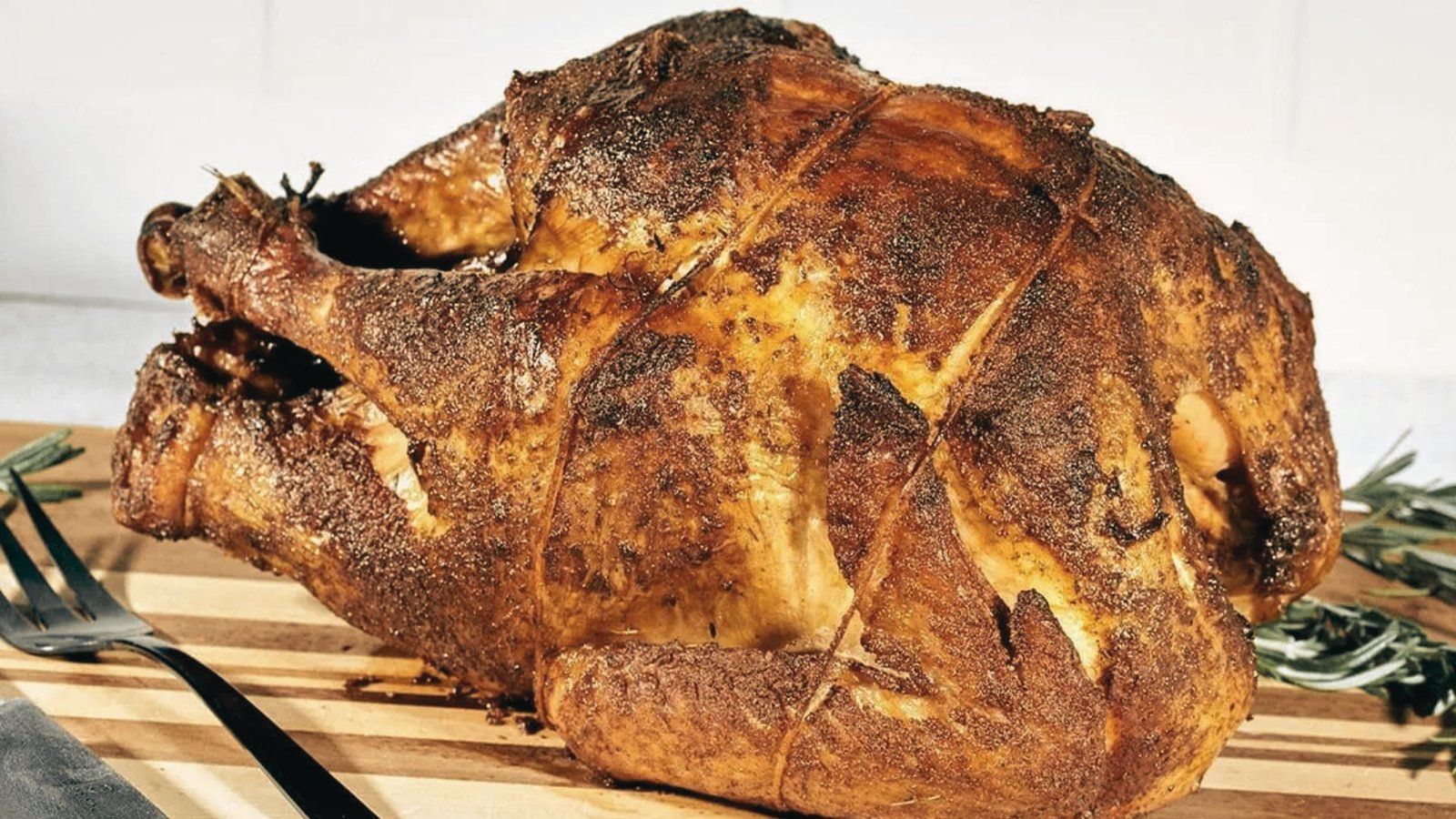 A whole roasted turkey resting on a cutting board, highlighting its crispy exterior and inviting presentation for a meal.