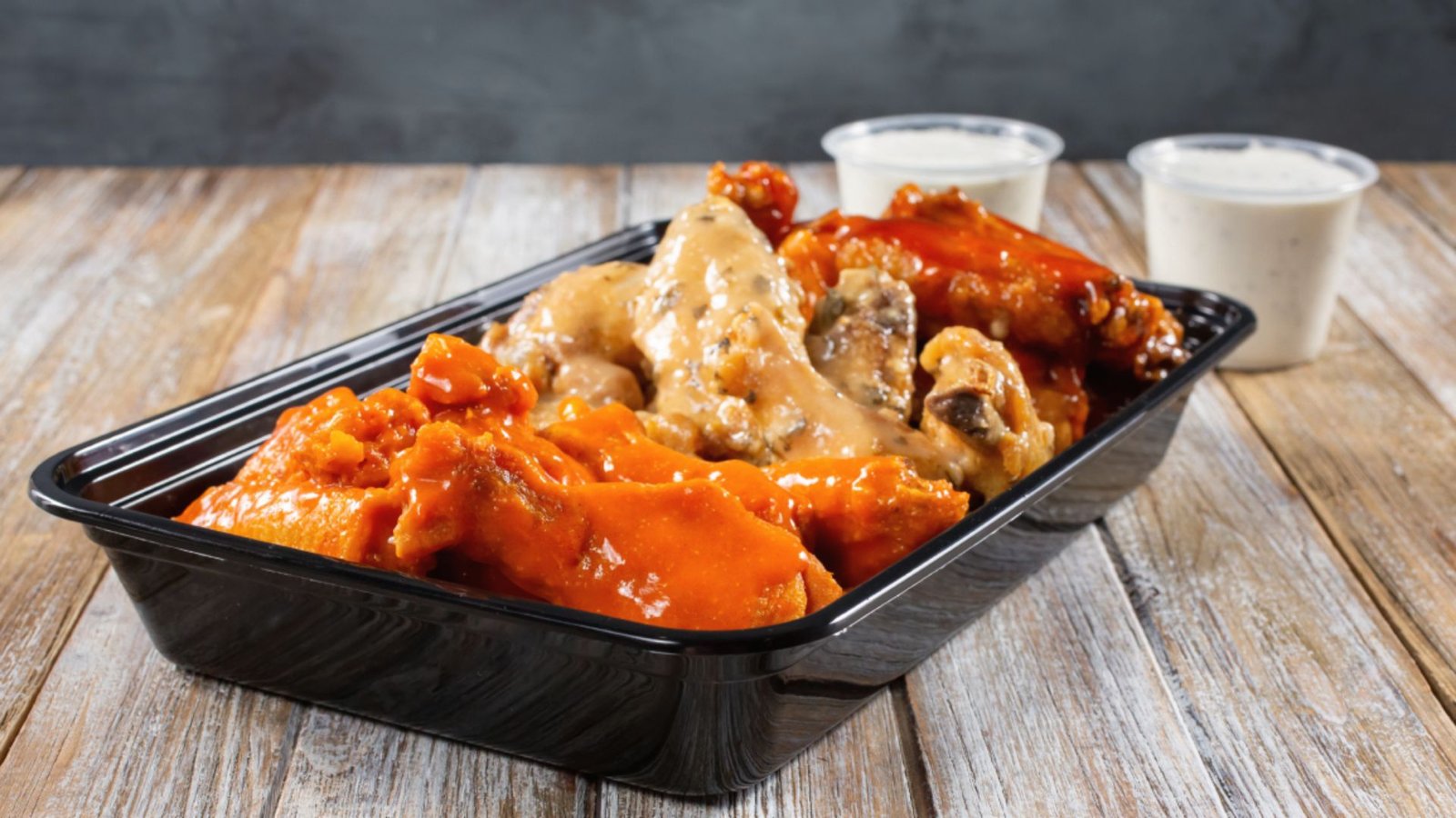 Chicken wings in a storage container.