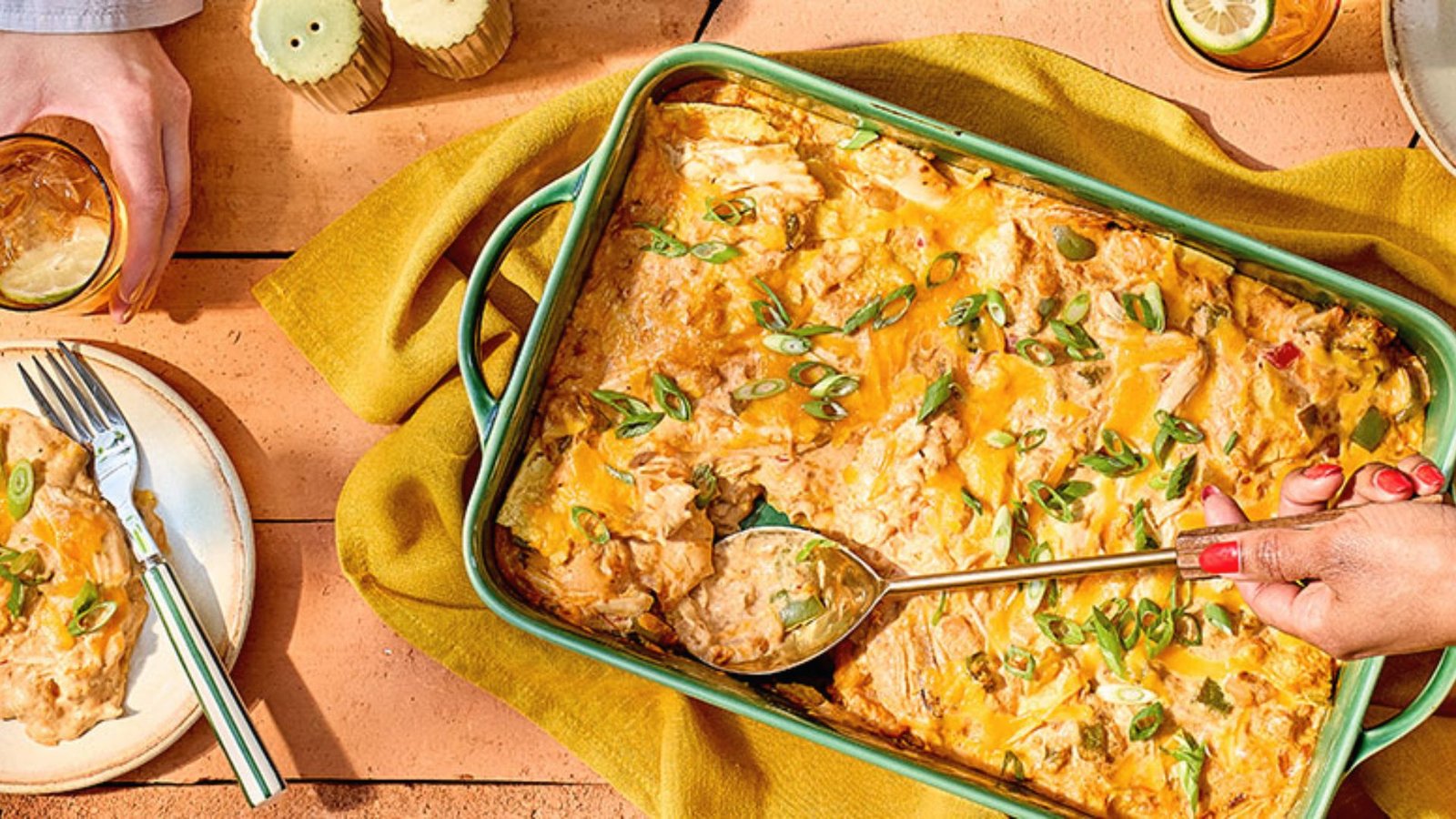 A casserole dish filled with chicken topped with melted cheese, ready to be served after resting.