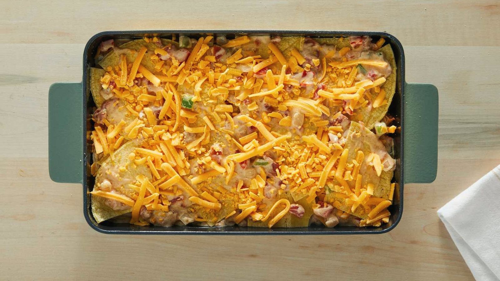 A casserole dish filled with layers of cheese and ham, demonstrating the proper layering technique for the recipe.