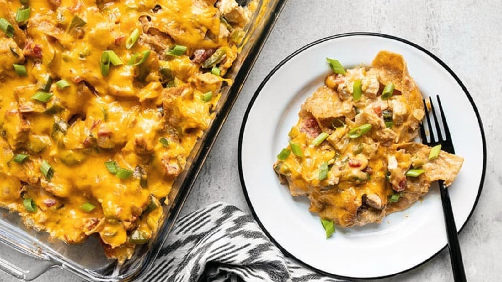 A hearty King Rancho chicken casserole featuring layers of tortilla chips, chicken, cheese, and spices, ready to serve.