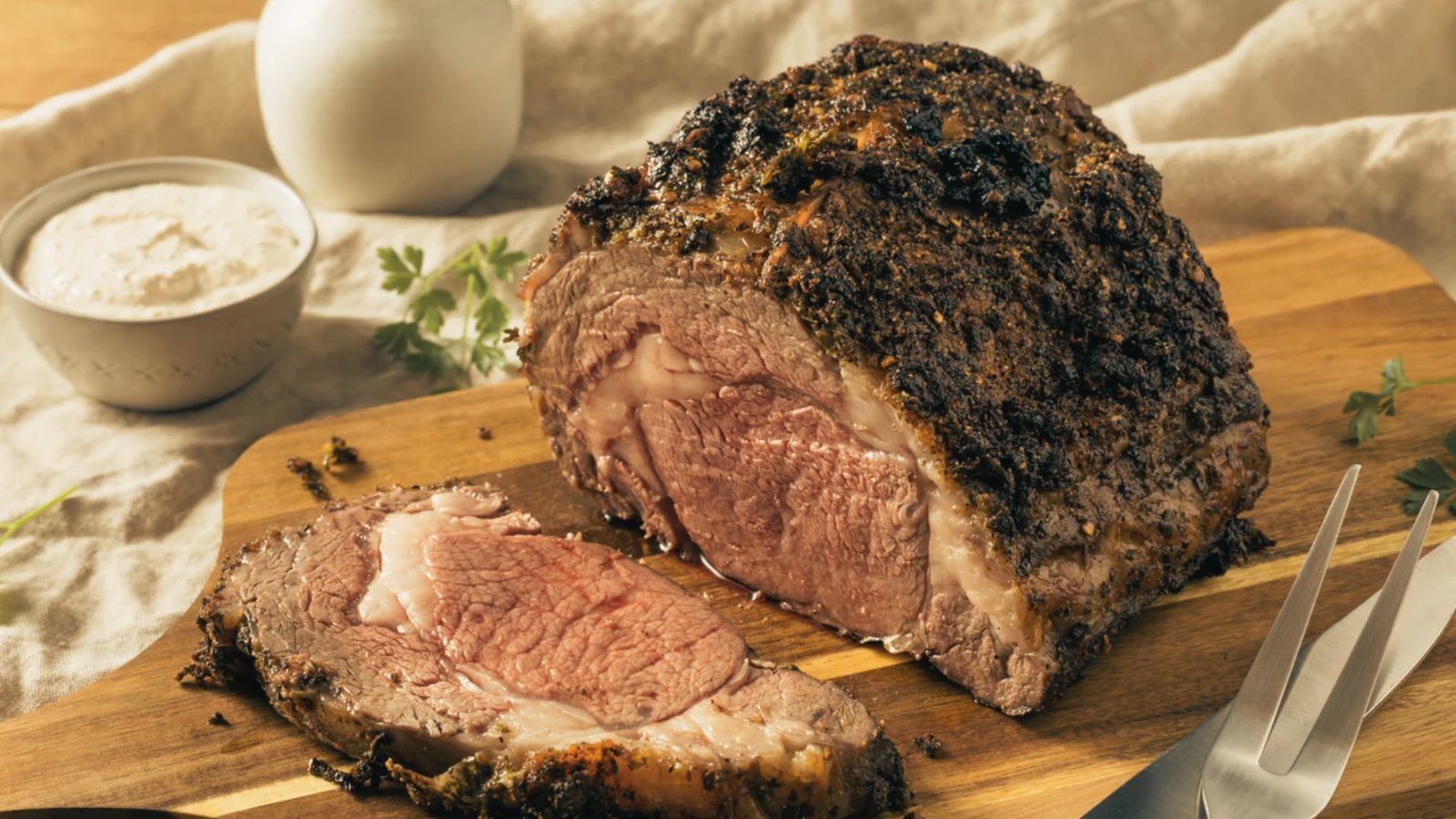 A raw Pikes Peak beef roast cut, showing a lean, cylindrical piece of meat with light marbling on a cutting board in a kitchen setting.