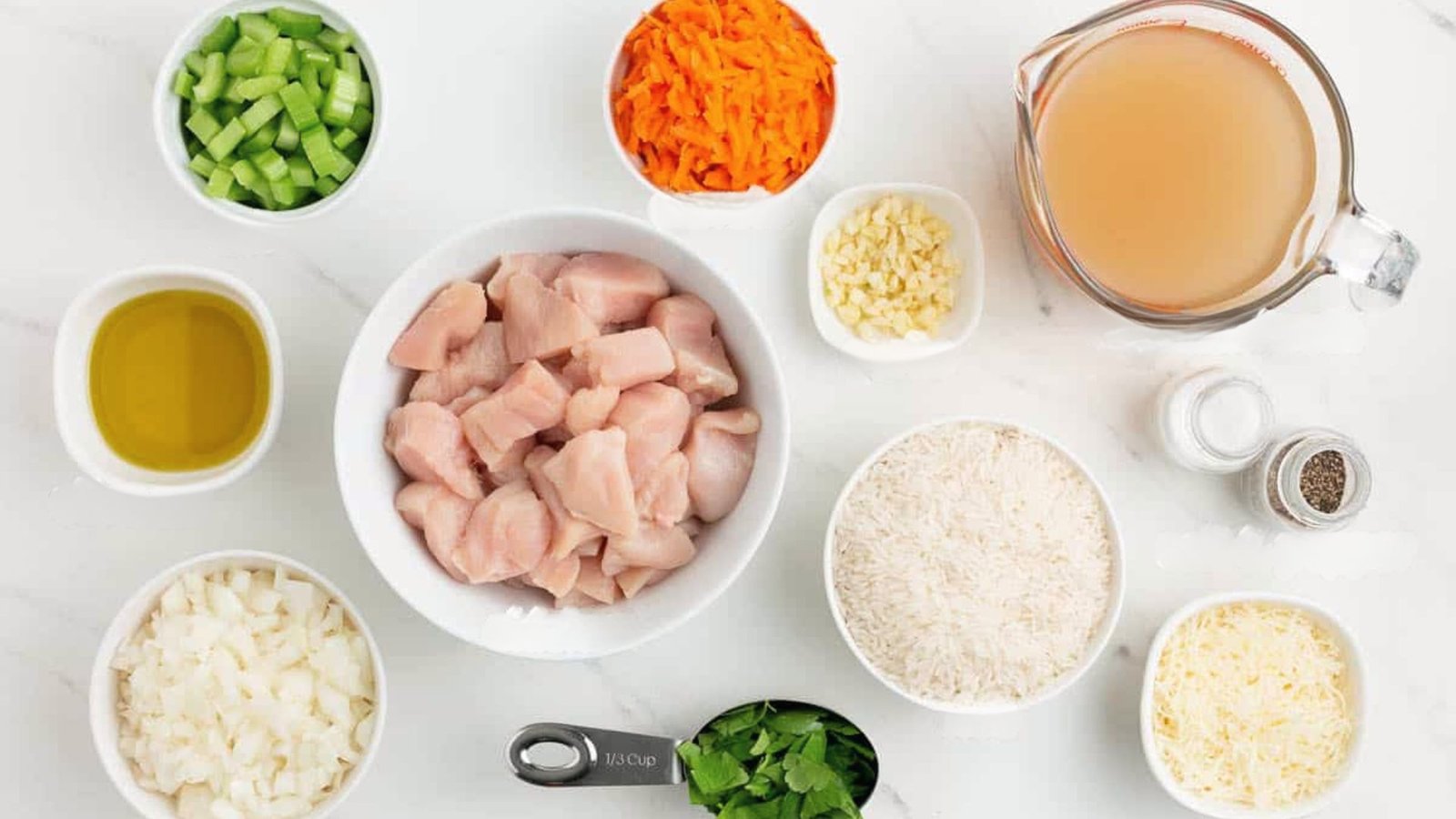 Bowls of ingredients for easy rice cooker chicken recipes, including rice, chicken, and various seasonings.
