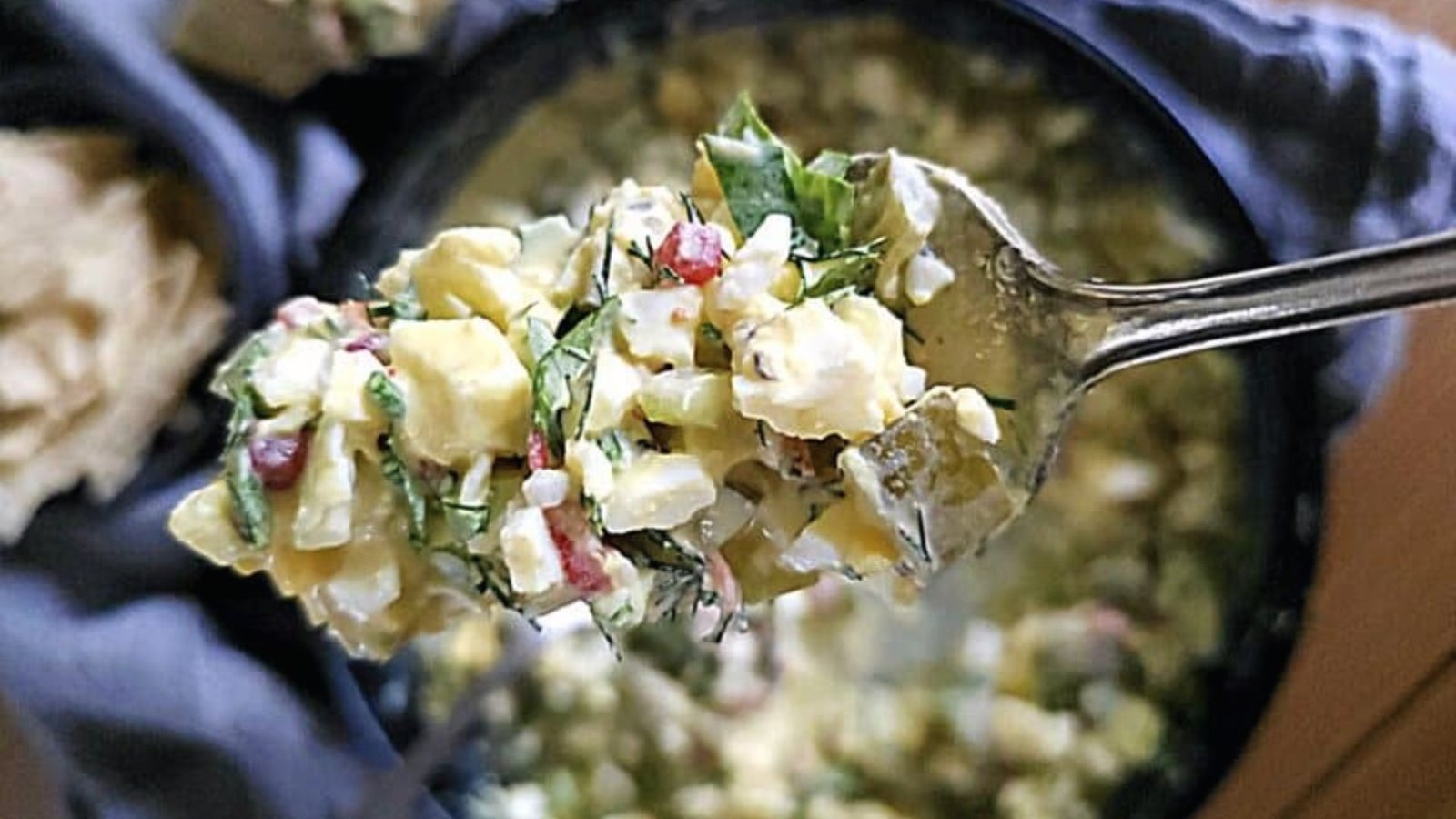 A fresh bowl of egg pickled salad, filled with assorted vegetables and coated in a flavorful dressing, appealingly arranged.