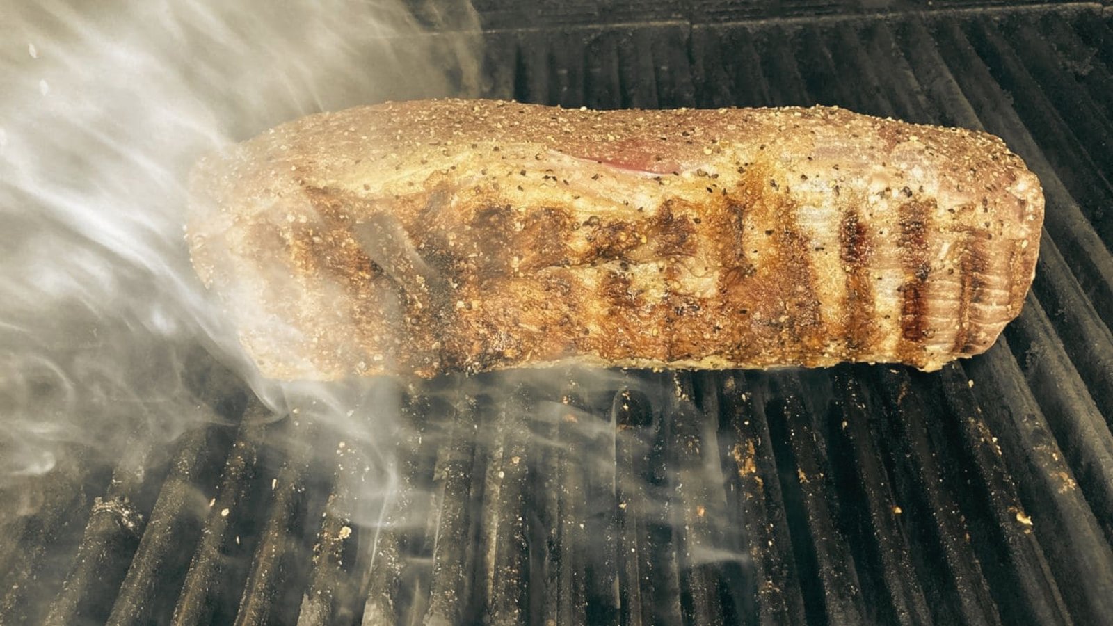 A grilled piece of meat, illustrating the Smoked Pikes Peak Roast method in action.