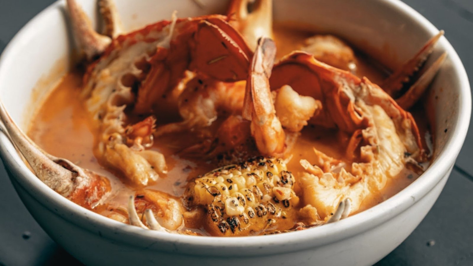 A bowl of seafood in a rich red sauce, showcasing the Killer Shrimp recipe influenced by Marina Del Rey style.