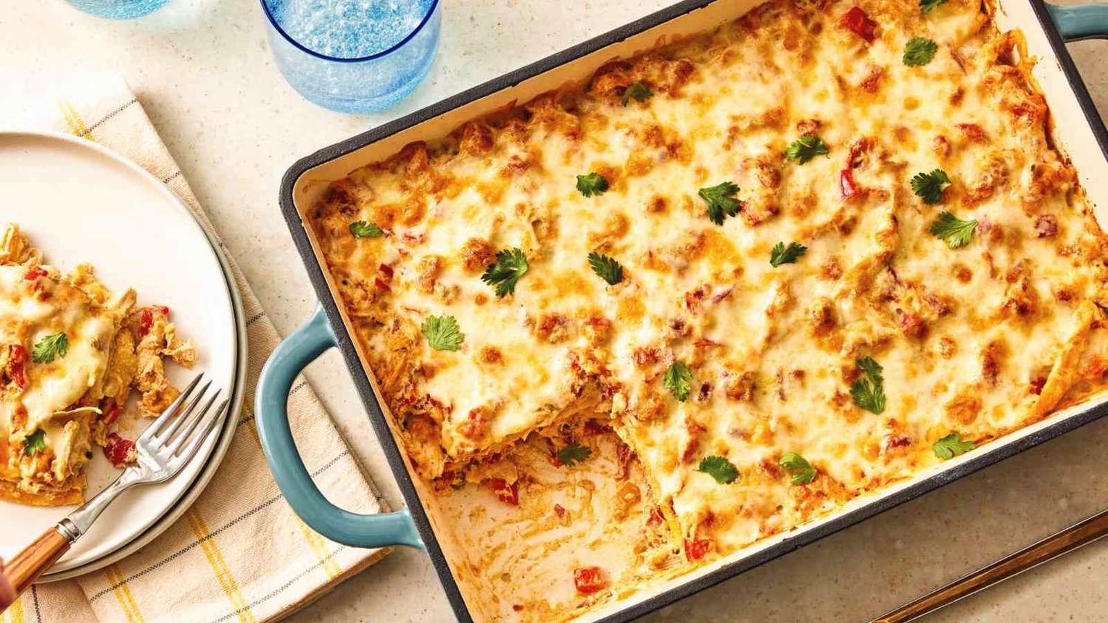 A close-up of a casserole dish containing a hearty mix of cheese and meat, showcasing King Ranch Chicken casserole.