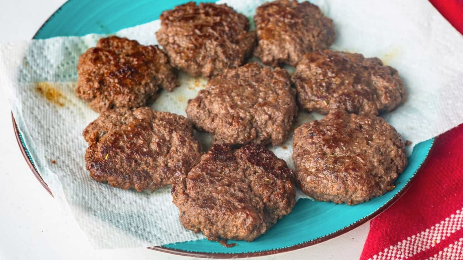 A plate of Deer Sausage sits on a red and white napkin, ready for tasting before stuffing.
