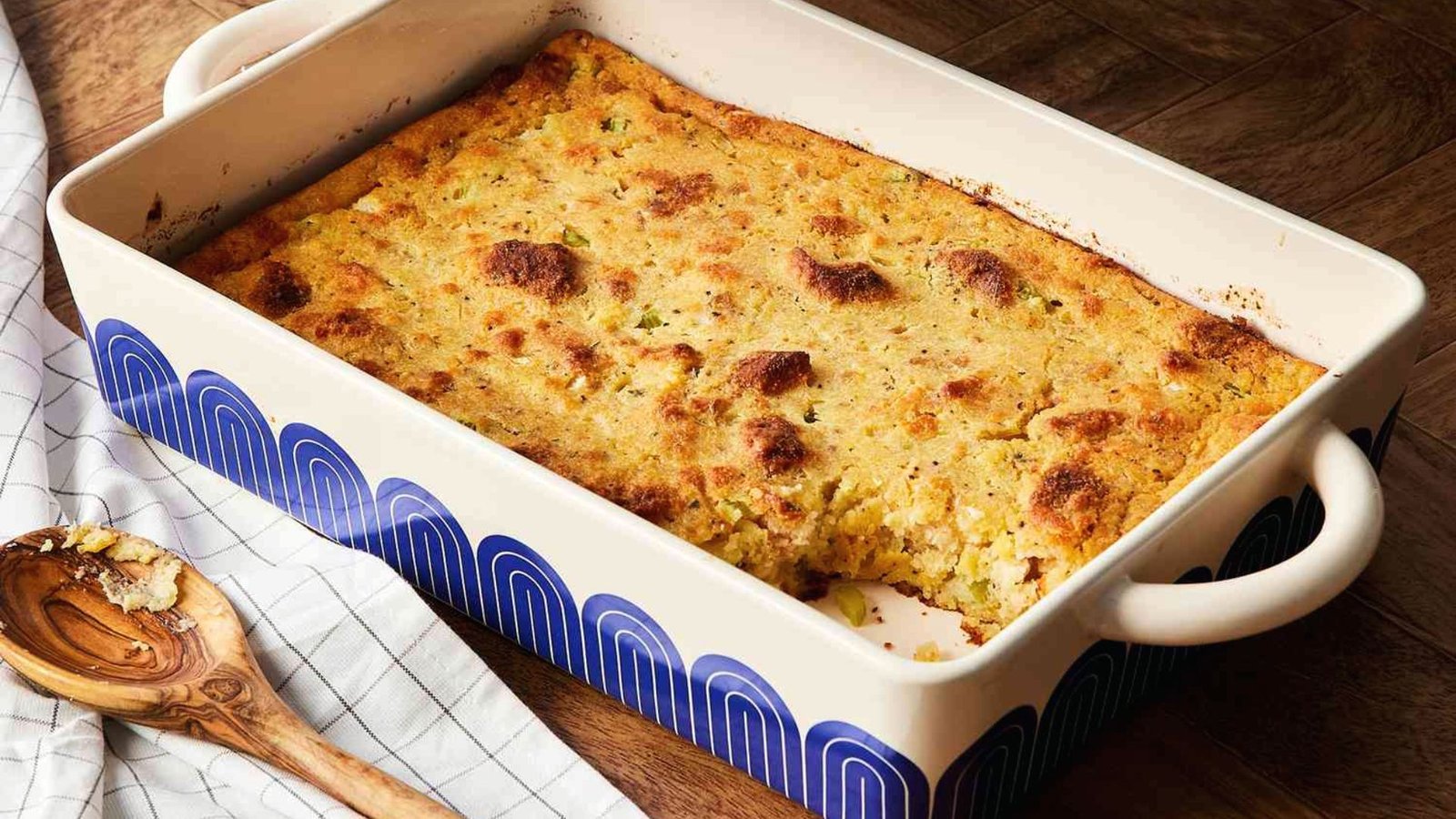 Cornbread casserole in a blue and white dish, baked until golden and set, ready to be served.