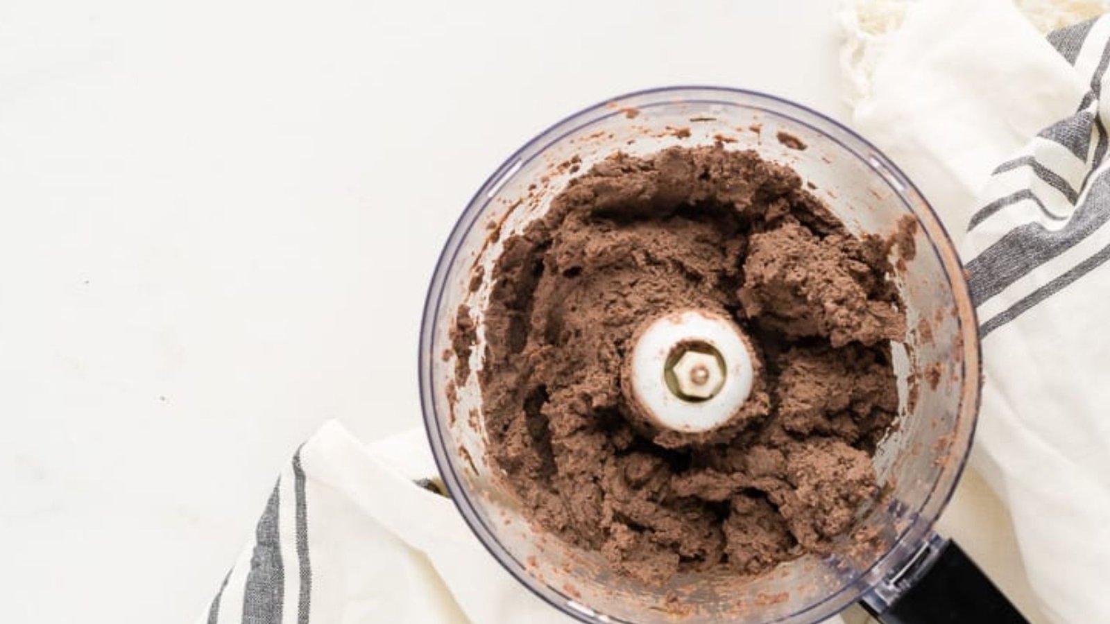A food processor filled with chicken liver dough, ready to be blended until turn smooth and creamy.