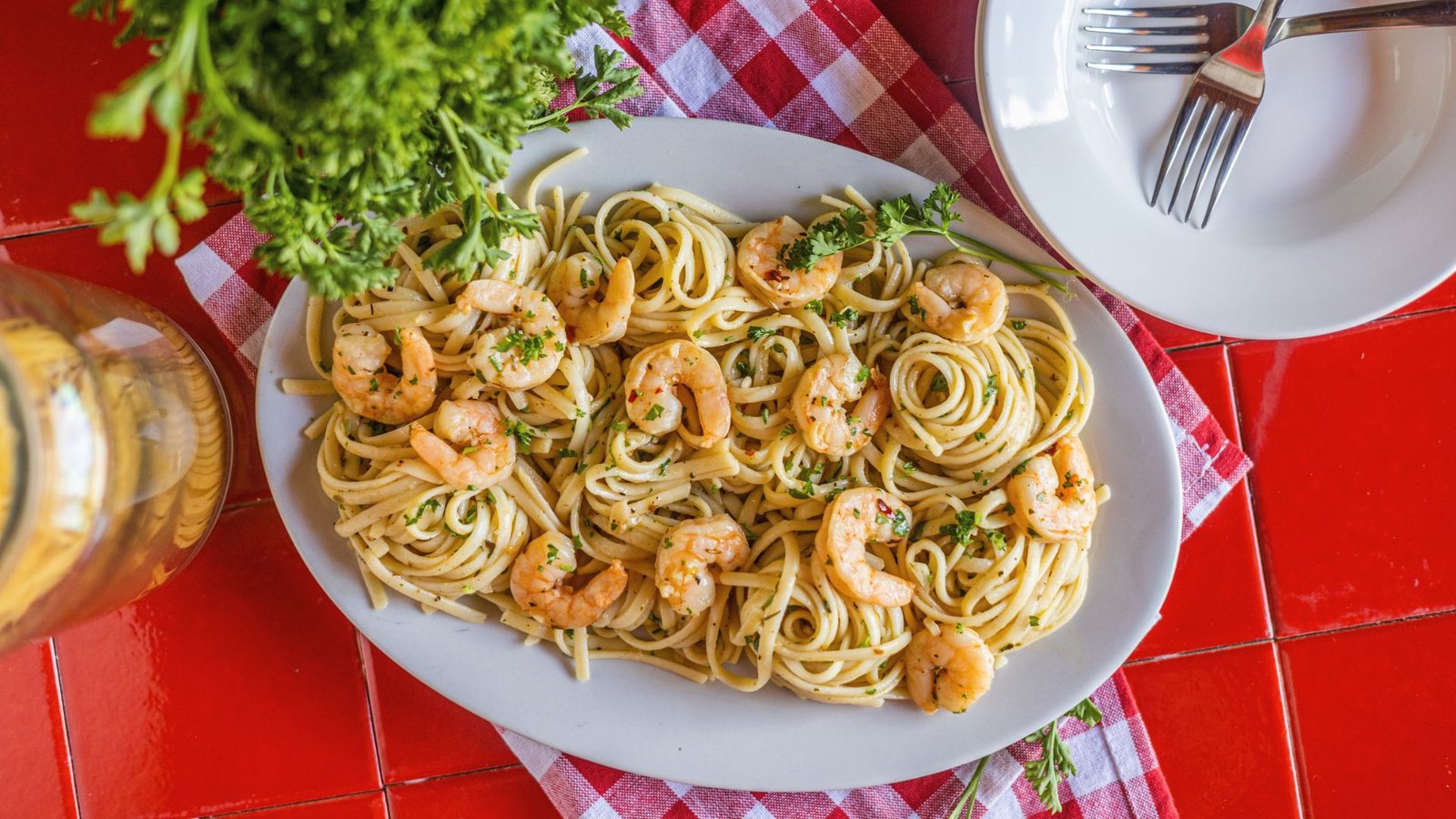 Shrimp and crab pasta garnished with garlic and parsley, showcasing a delicious seafood dish perfect for pasta lovers.