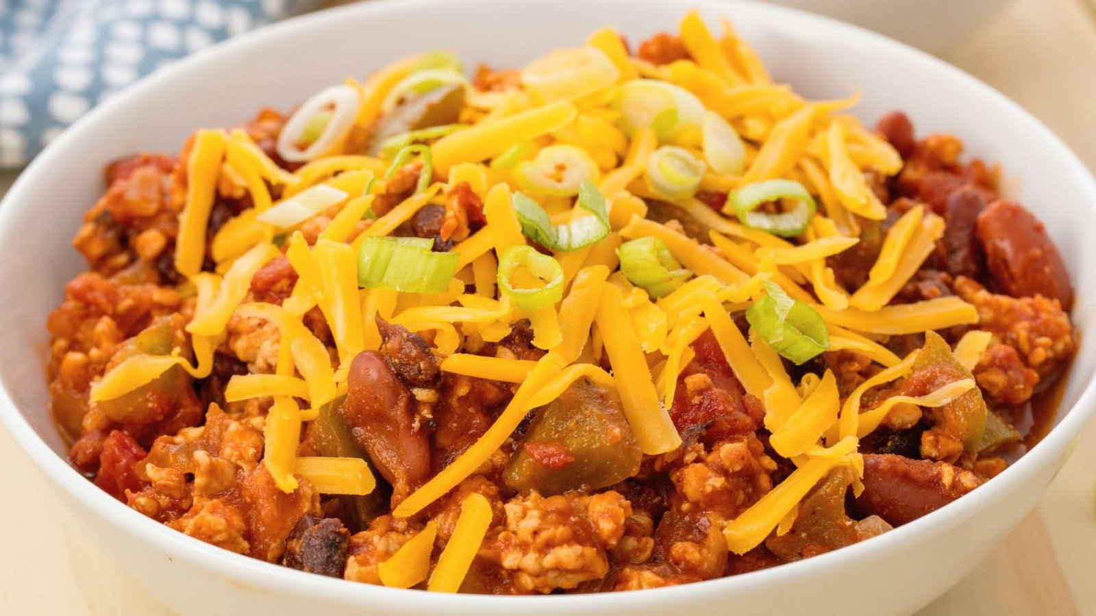 A bowl of chili con carne, showcasing rich meat and beans, perfect for serving with Barefoot Contessa's turkey chili recipe.