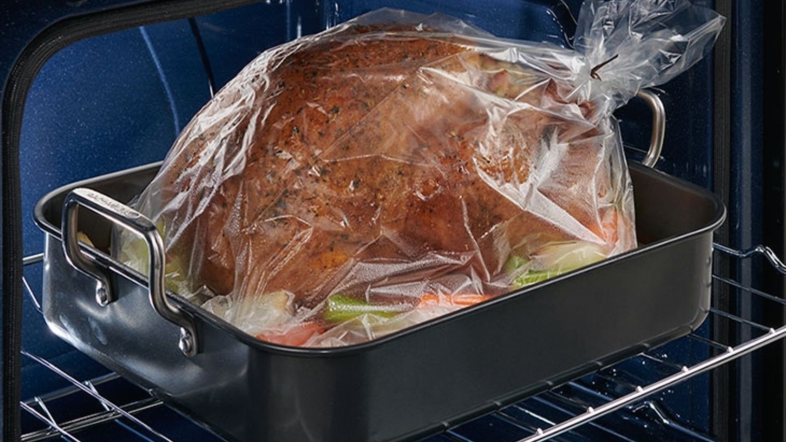 A turkey placed in a plastic bag on an oven rack, demonstrating the process for the Best Turkey in Bag Recipe.