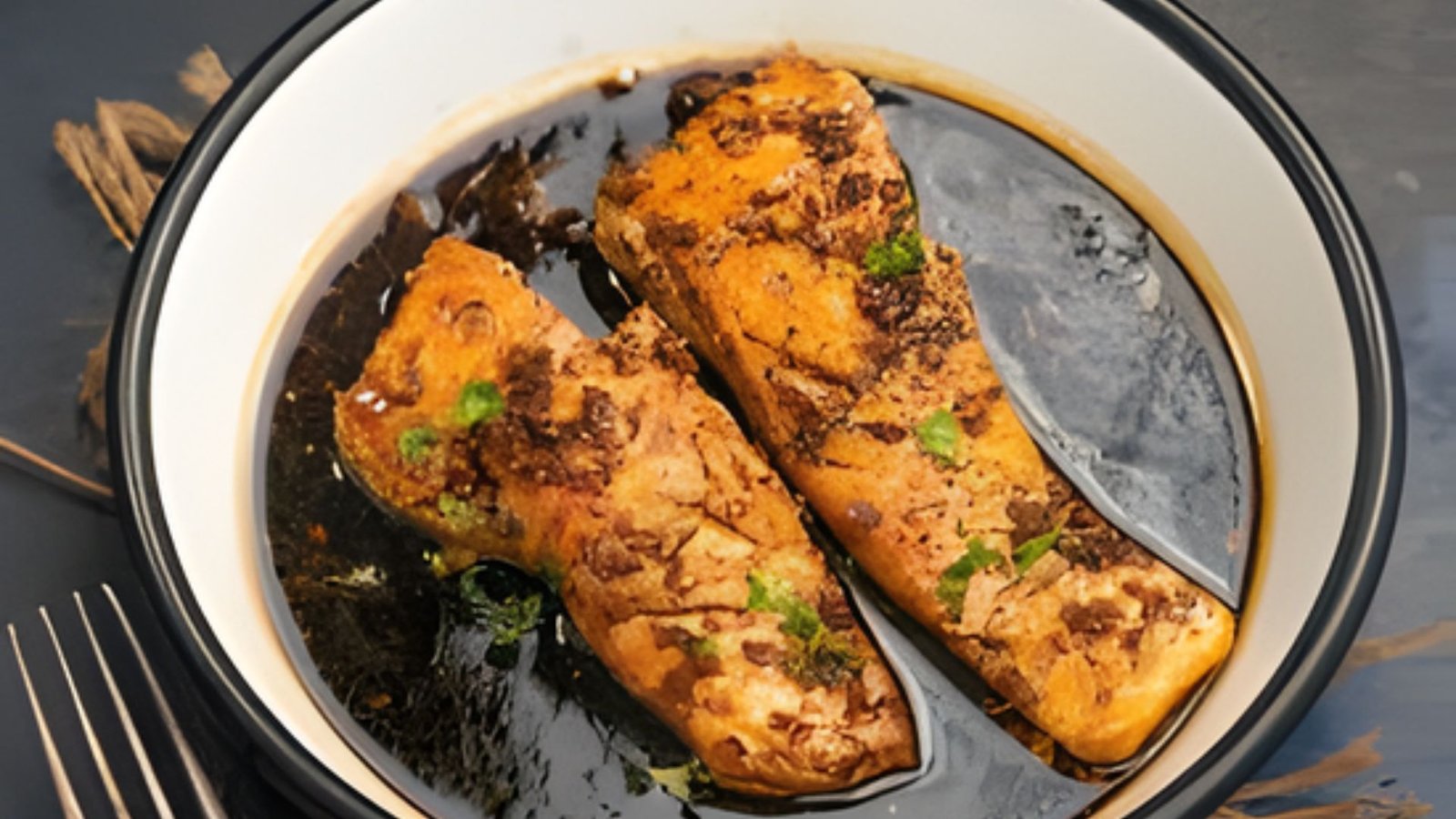 Two pieces of salmon in a flavorful herb sauce, inspired by Japanese steakhouse cooking techniques.