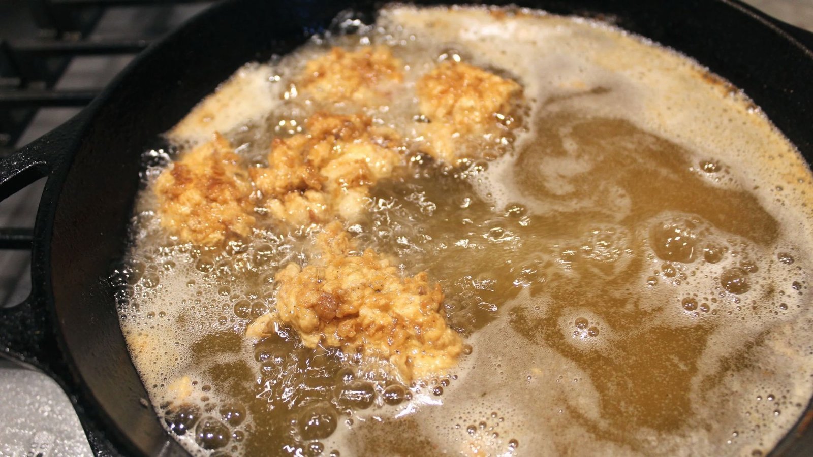 A pan filled with lobster bites golden-brown, sizzling and ready to serve.
