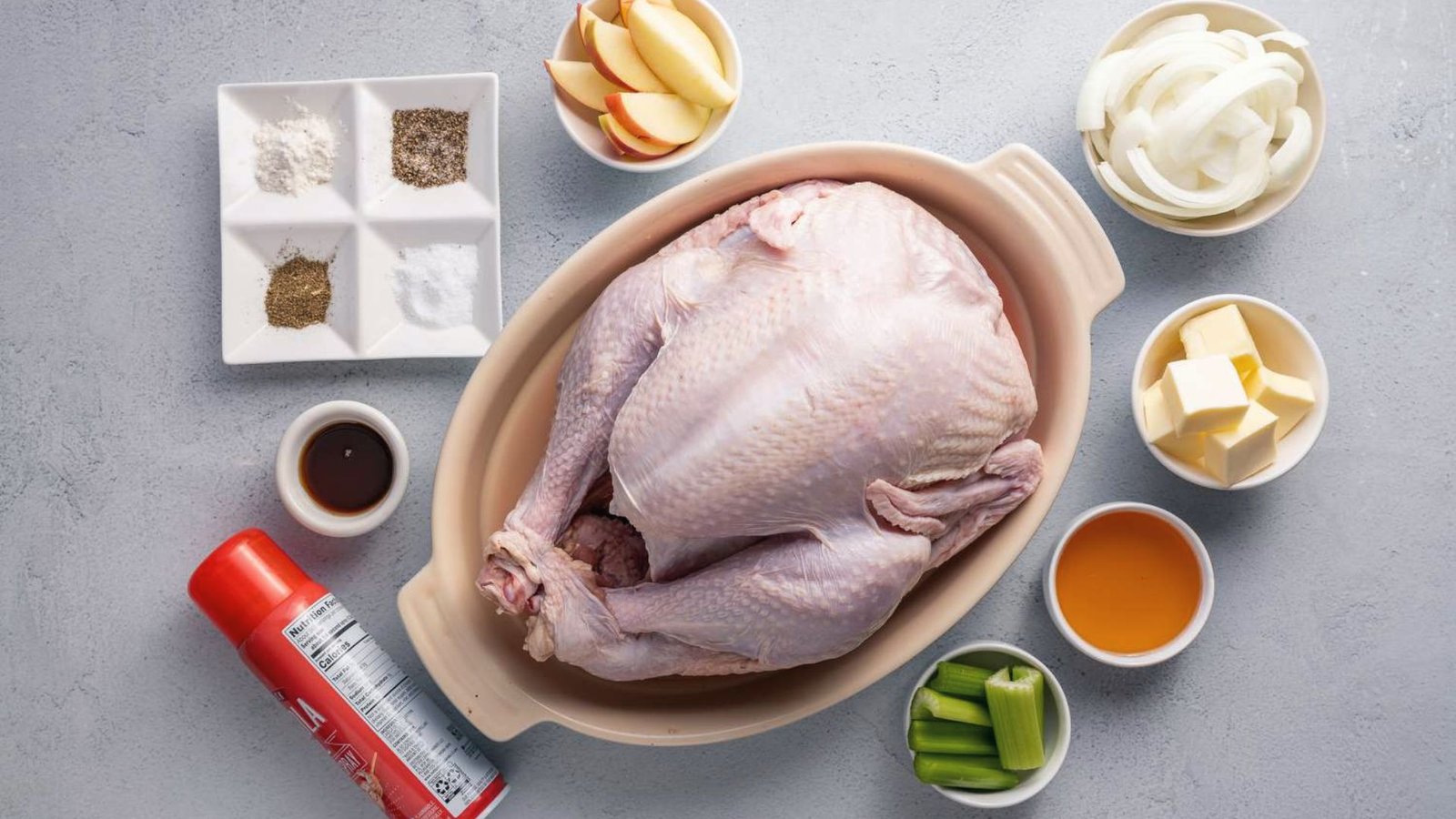 A table displaying ingredients and tools for cooking a turkey in a bag recipe, including spices and utensils.