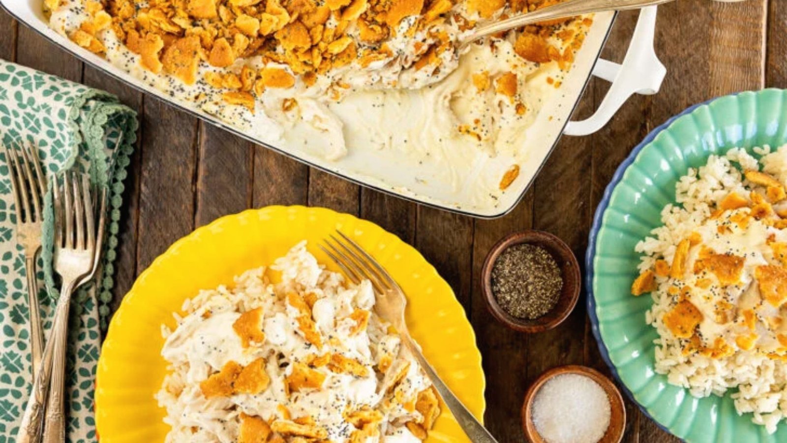 A casserole dish filled with poppyseed chicken and rice sits on a table, showcasing a delicious meal ready to serve.